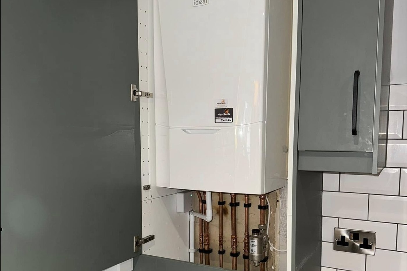 Combi boiler installed in a kitchen cupboard